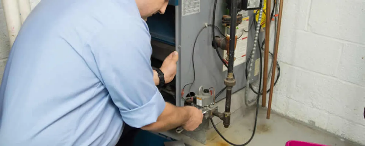 Furnace repair technician inspecting and servicing a home heating system in Sarasota, FL