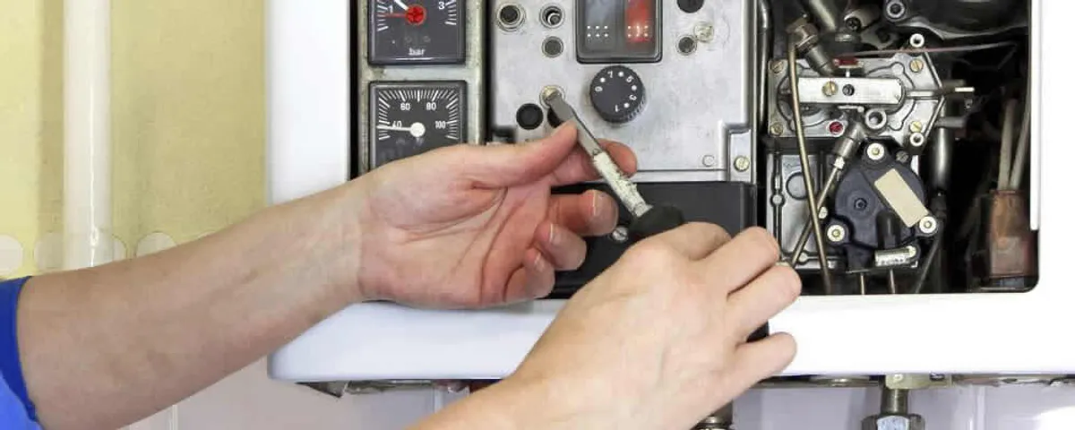 Heating repair technician adjusting boiler controls and components in Sarasota, FL