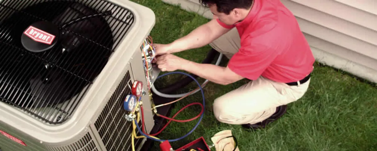 HVAC technician servicing an outdoor air conditioner unit in Sarasota, FL