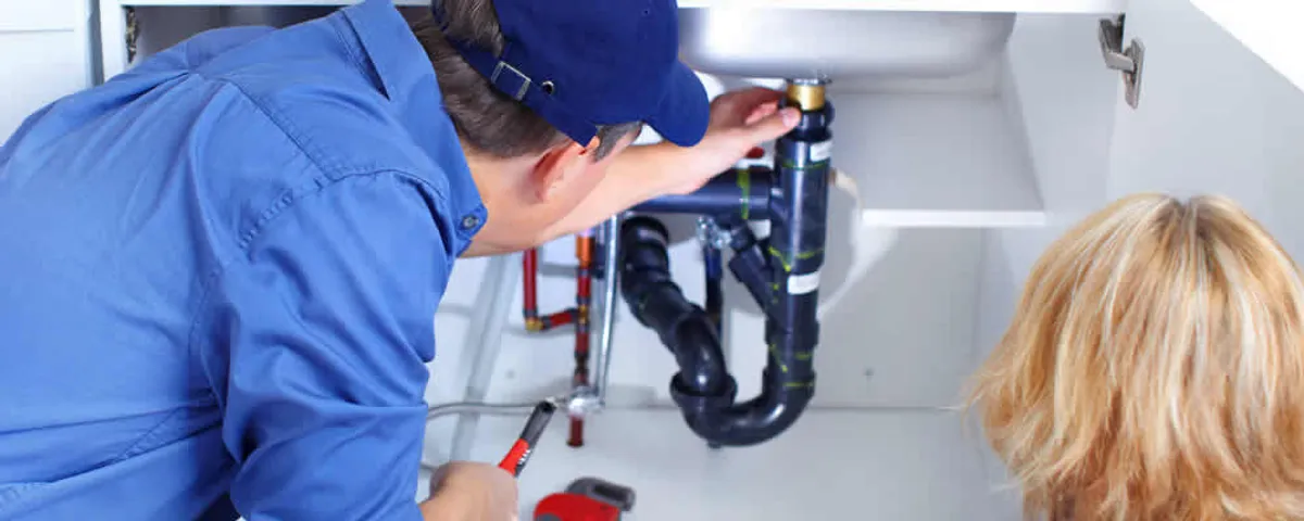 Plumber repairing under-sink drain pipes and fittings in Sarasota, FL